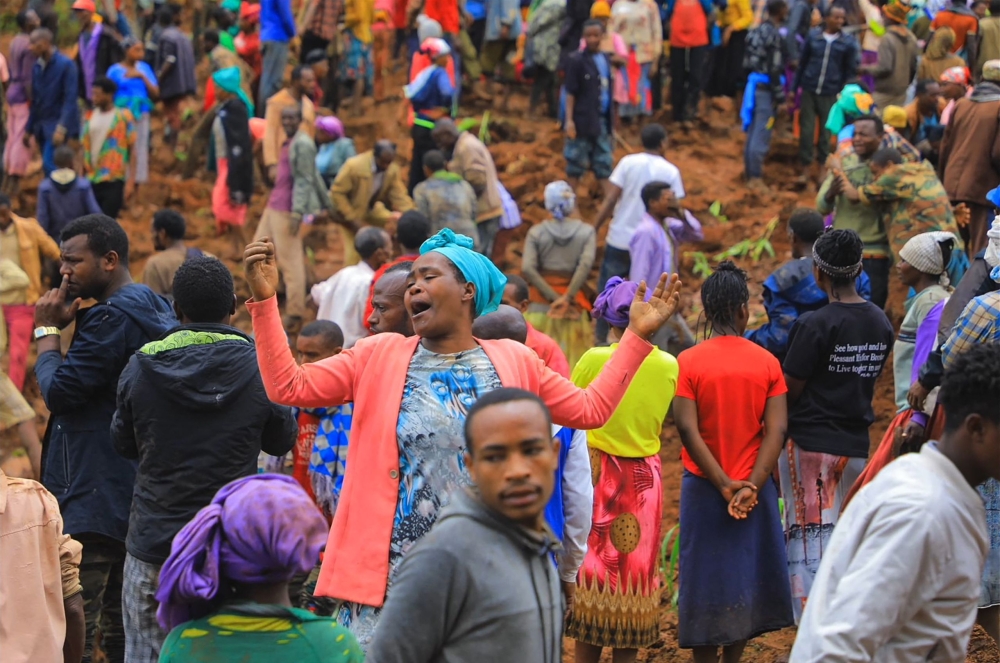 This grab made from a handout footage released by the Gofa Zone Government Communication Affairs Department on July 22, 2024, shows people standing at the bottom of a landslide that occurred in the Geze-Gofa district. (Photo by Gofa Zone Government Communication Affairs Department/ESN / AFP) /