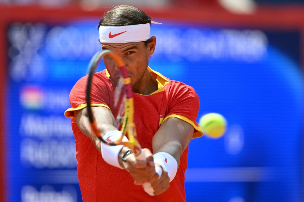 Spain's Rafael Nadal warms up ahead of his men's singles first round tennis match against Hungary's Marton Fucsovics on Court Philippe-Chatrier at the Roland-Garros Stadium at the Paris 2024 Olympic Games, in Paris on July 28, 2024. (Photo by Miguel MEDINA / AFP)