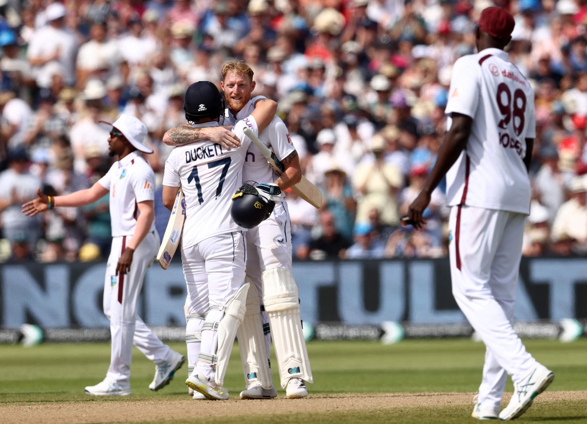 England's captain Ben Stokes celebrates (C) with England's Ben Duckett (L) after winning on the third day of the third Test cricket match between England and West Indies at Edgbaston in Birmingham, central England on July 28, 2024.. (Photo by Darren Staples / AFP) 