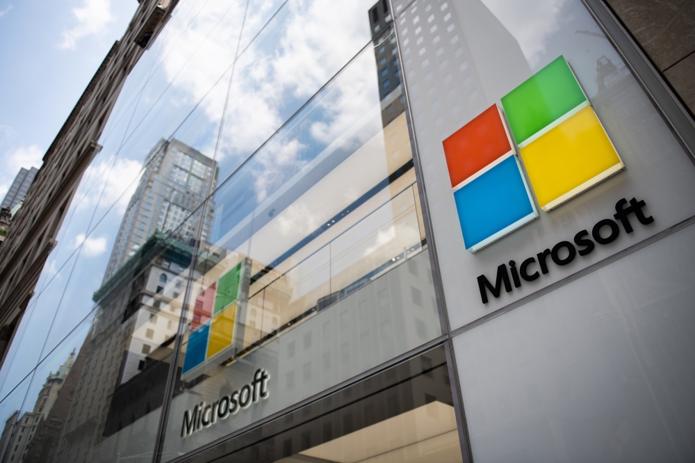 File: A sign hangs on the exterior of the Microsoft Corp. Fifth Avenue flagship store in New York on July 14, 2018. (Photo by Mark Kauzlarich/Bloomberg)
