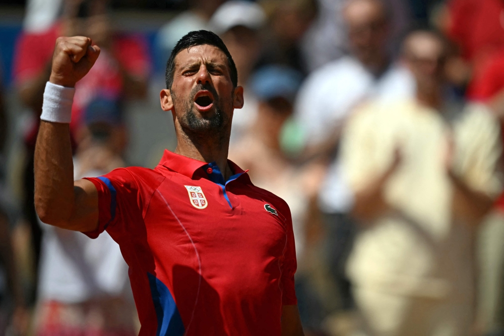 Serbia's Novak Djokovic react to beating Germany's Dominik Koepfer on Court Philippe-Chatrier at the Roland-Garros Stadium in Paris on July 31, 2024. (Photo by Carl De Souza / AFP)
 