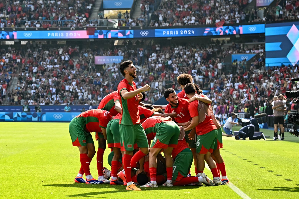 Morocco's players celebrate after scoring their third goal during the men's quarter-final football match between Morocco and the USA at the Paris 2024 Olympic Games at the Parc des Princes in Paris on August 2, 2024. Photo by Paul ELLIS / AFP.