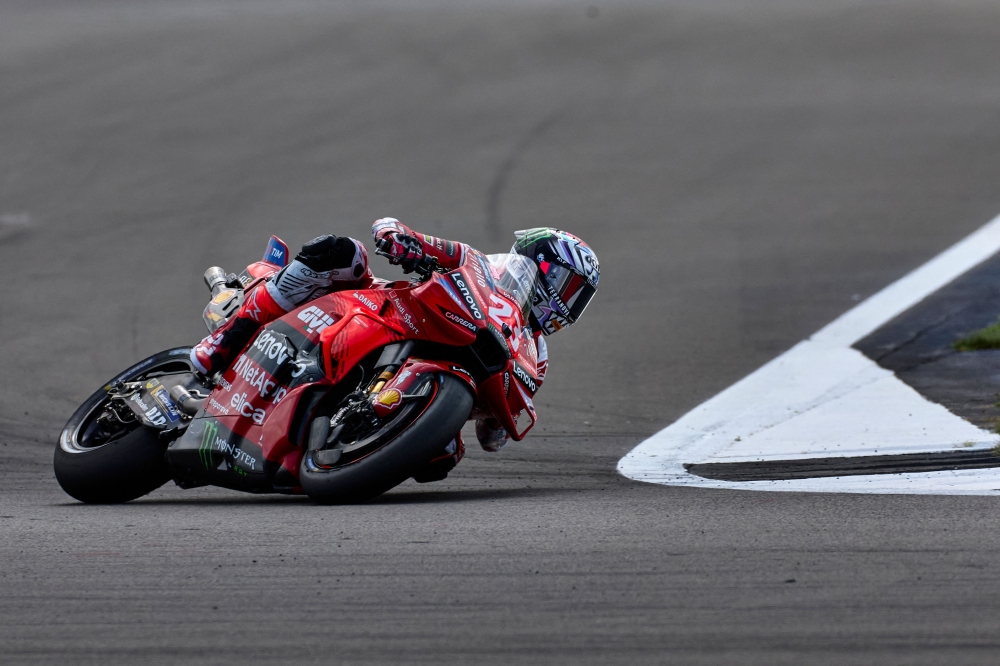 Ducati Lenovo Team's Italian rider Enea Bastianini takes part in the qualifying session of the MotoGP British Grand Prix at Silverstone circuit in Northamptonshire, central England, on August 3, 2024. (Photo by BENJAMIN CREMEL / AFP)
