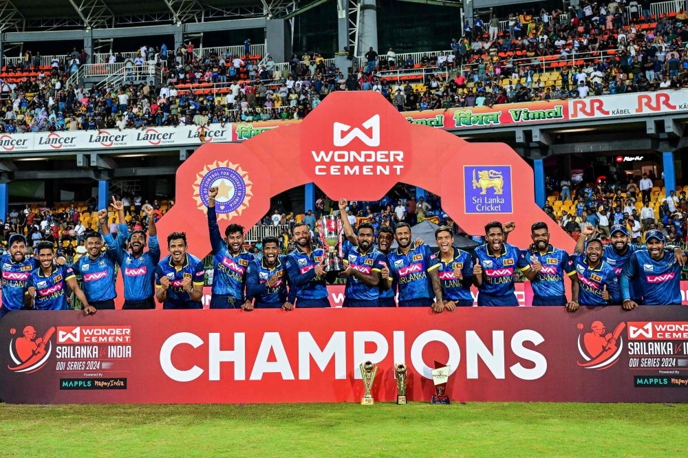 Sri Lanka's players pose with the series trophy after winning the third and final one-day international (ODI) cricket match between Sri Lanka and India at the R. Premadasa International cricket Stadium in Colombo on August 7, 2024. (Photo by Ishara S. Kodikara / AFP)
