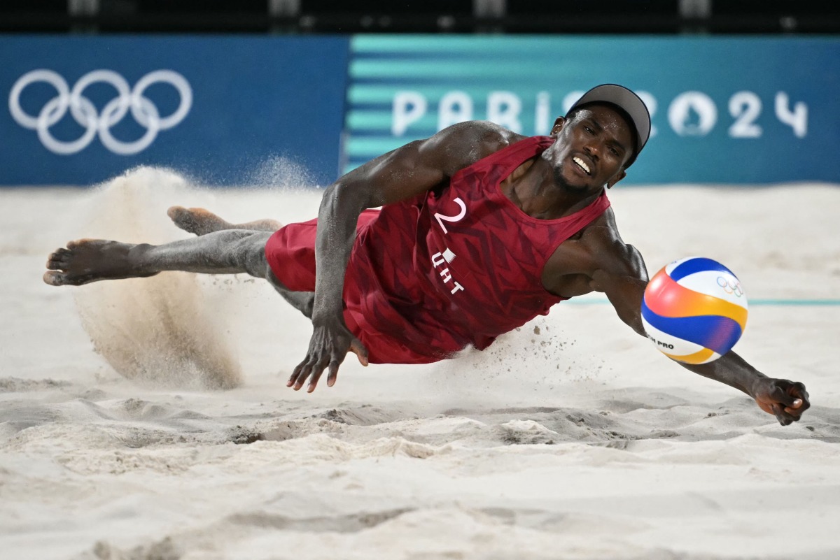 Ahmed Tijan dives to reach the ball during yesterday's semi-final between Qatar and Sweden. Pictures: AFP