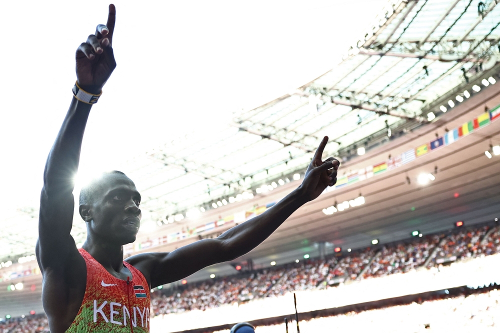 Gold medallist Kenya's Emmanuel Wanyonyi celebrates after the men's 800m final of the athletics event at the Paris 2024 Olympic Games at Stade de France in Saint-Denis, north of Paris, on August 10, 2024. (Photo by Anne-Christine POUJOULAT / AFP)
