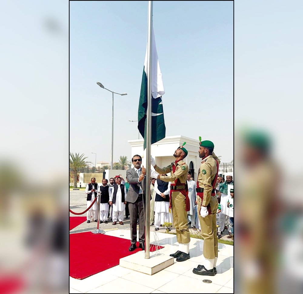 Pakistan Ambassador H E Muhemmed Aejaz hoisting the Pakistan flag at the ceremony.