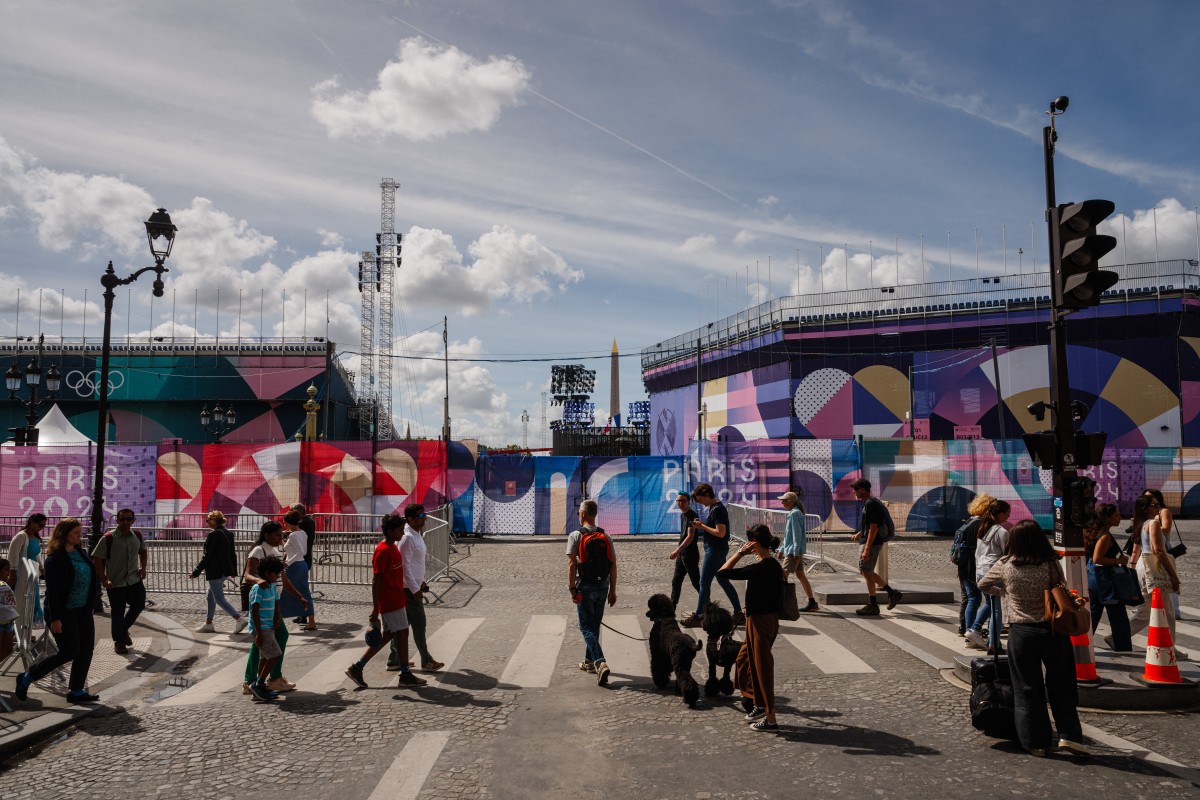 Pedestrians walk by the Place de la Concorde Paralympic site covered in 