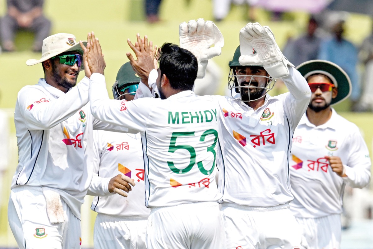 Bangladesh’s Mehidy Hasan Miraz (centre) celebrates with teammates after taking the wicket of Pakistan’s Mohammad Rizwan yesterday. 