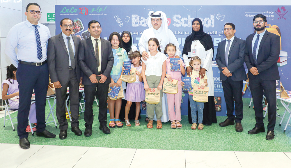 Officials with children during the event at Lulu branch in the Old Airport area.