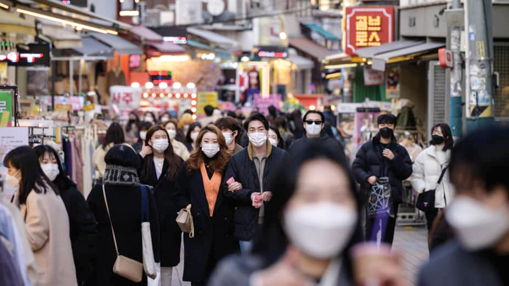 People walk along a commercial street in Seoul, S Korea. (AFP)