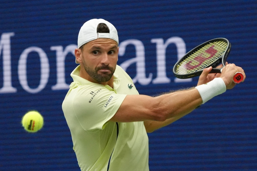 Bulgaria's Grigor Dimitrov plays a return to Russia's Andrey Rublev during their men's singles round of 16 match on day seven of the US Open tennis tournament at the USTA Billie Jean King National Tennis Center in New York City, on September 1, 2024. (Photo by TIMOTHY A. CLARY / AFP)
