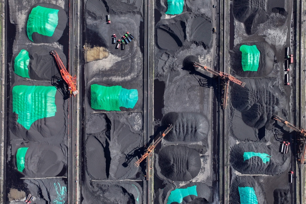 (Files) Coal is sorted into piles at a coal yard at the port in Ningbo, in China's eastern Zhejiang province on July 16, 2024. (Photo by AFP) 