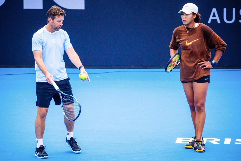 (Files) Japan's Naomi Osaka (R) and coach Wim Fissette attend a training session ahead of the Brisbane International tennis tournament at Pat Rafter Arena in Brisbane on December 27, 2023.  (Photo by Patrick HAMILTON / AFP) 