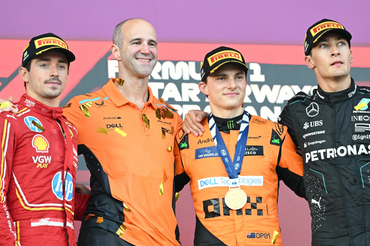 Second placed Ferrari's Monegasque driver Charles Leclerc, winner McLaren's Australian driver Oscar Piastri and third placed Mercedes' British driver George Russell celebrate on the podium after the Formula One Azerbaijan Grand Prix at the Baku City Circuit in Baku on September 15, 2024. Photo by Natalia KOLESNIKOVA / AFP.