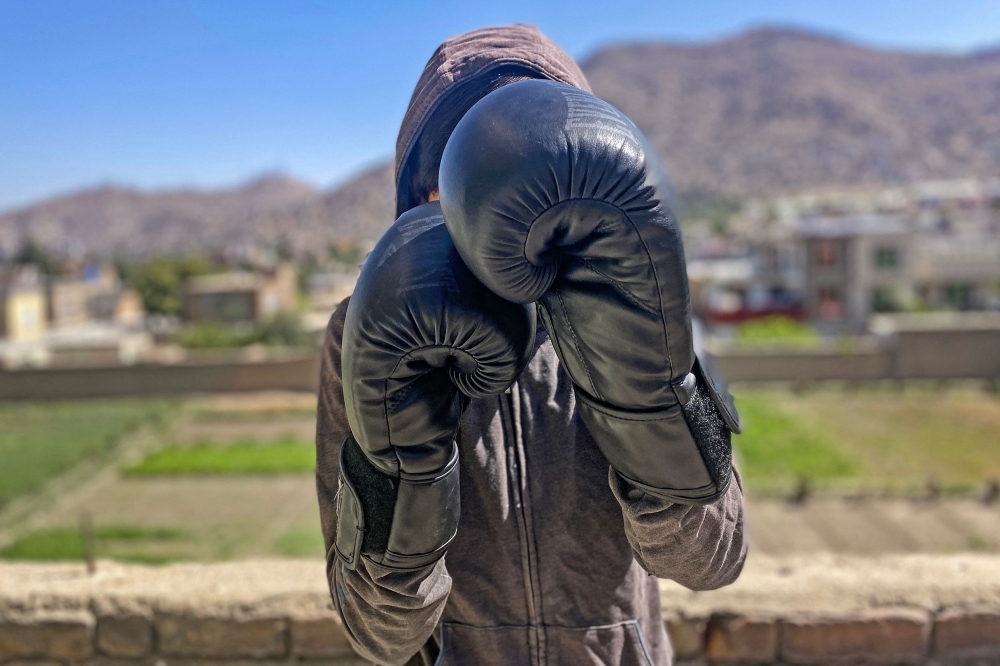 In this photograph taken on July 7, 2024, an Afghan female boxer poses during a training session in Kabul. (Photo by AFP) 

