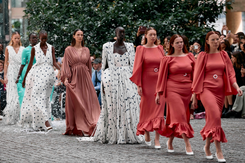 Models present creations during a catwalk presentation for the Edeline Lee Spring/Summer 2025 collection, at London Fashion Week in London, on September 16, 2024. (Photo by BENJAMIN CREMEL / AFP)