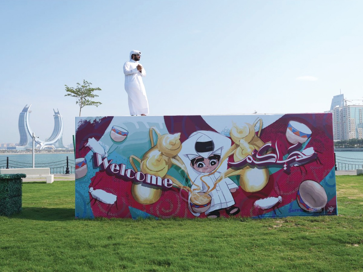 Qatari artist Mohammed AlEmadi standing on top of one of his installations.