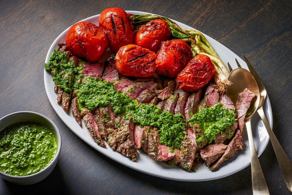 Grilled skirt steak with arugula chimichurri. (Photo by Rey Lopez for The Washington Post; food styling by Lisa Cherkasky for The Washington Post )

