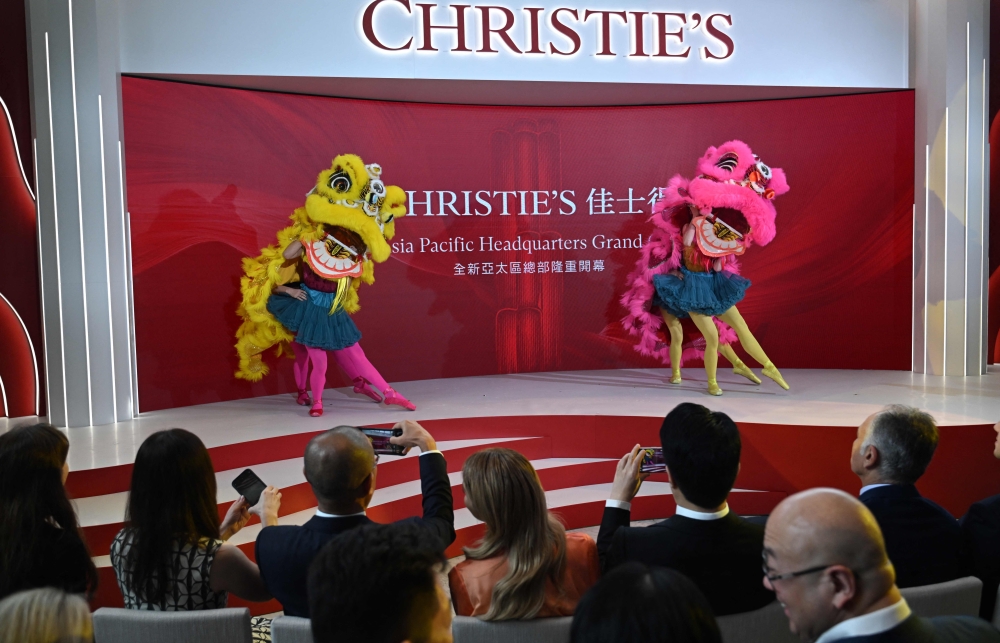 Lion dancers perform in front of guests at the official unveiling of Christie's new Asia Pacific headquarters at the Henderson Centre in Hong Kong on September 20, 2024. (Photo by Peter PARKS / AFP)