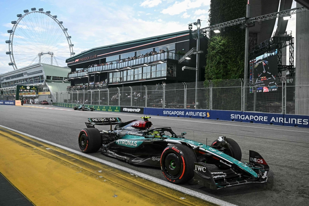 Mercedes' British driver Lewis Hamilton drives during the third practice session ahead of the Formula One Singapore Grand Prix in Singapore on September 21, 2024. (Photo by Lillian Suwanrumpha / AFP)
 