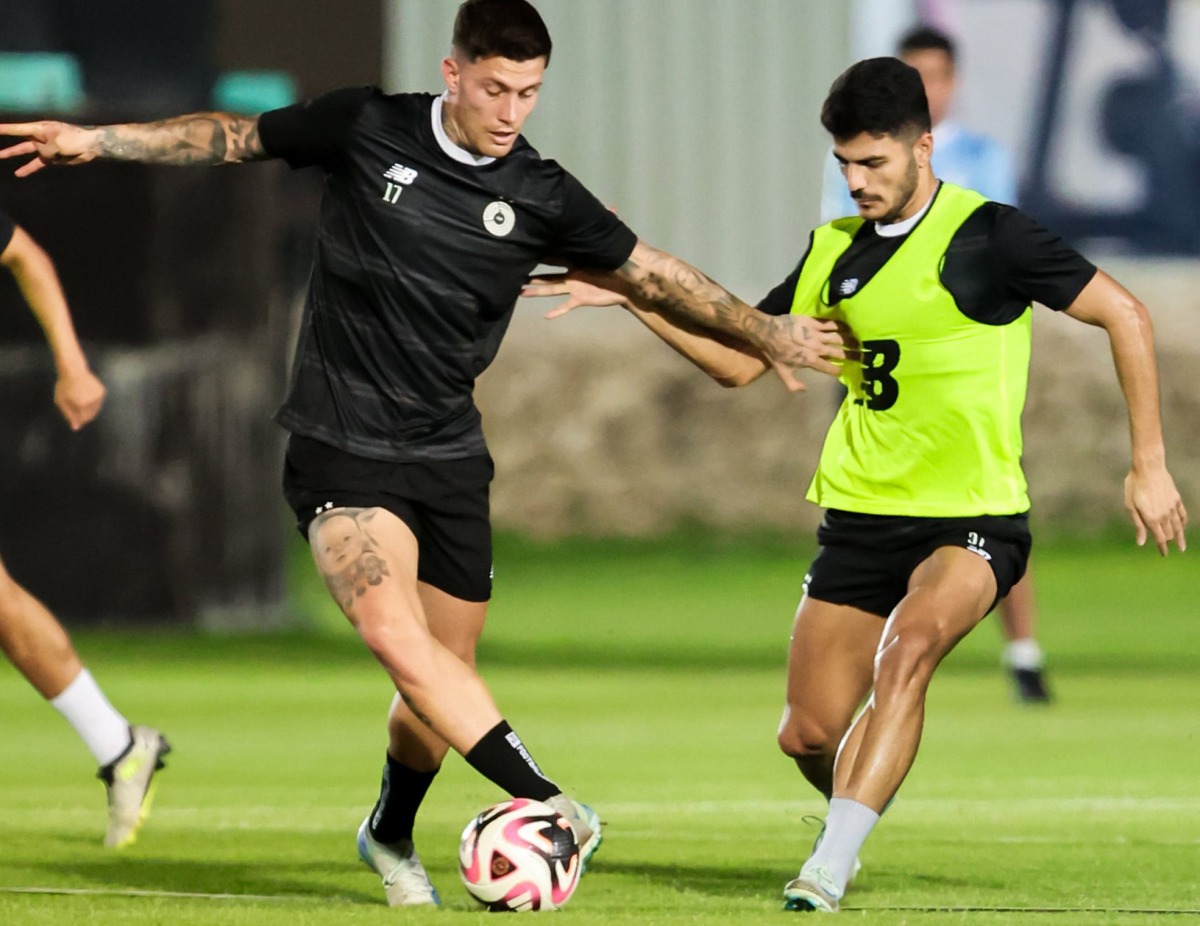 Al Sadd's Cristo Gonzalez (left) trains with a teammate.