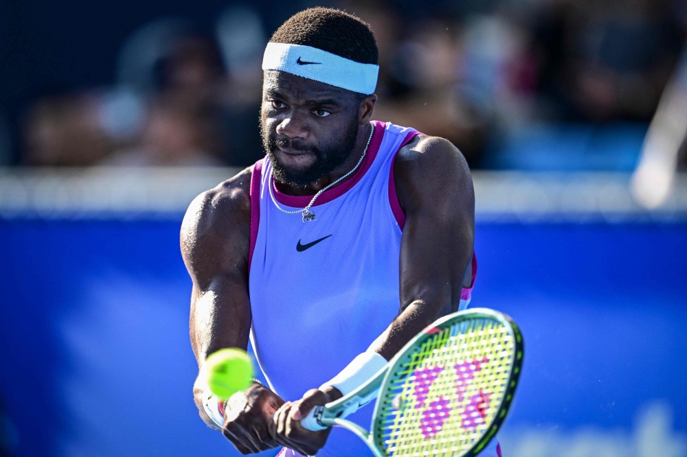 Frances Tiafoe of the US hits a return to Brandon Nakashima of the US during their men's singles match at the Japan Open tennis tournament in Tokyo on September 26, 2024. (Photo by Yuichi Yamazaki / AFP)
 