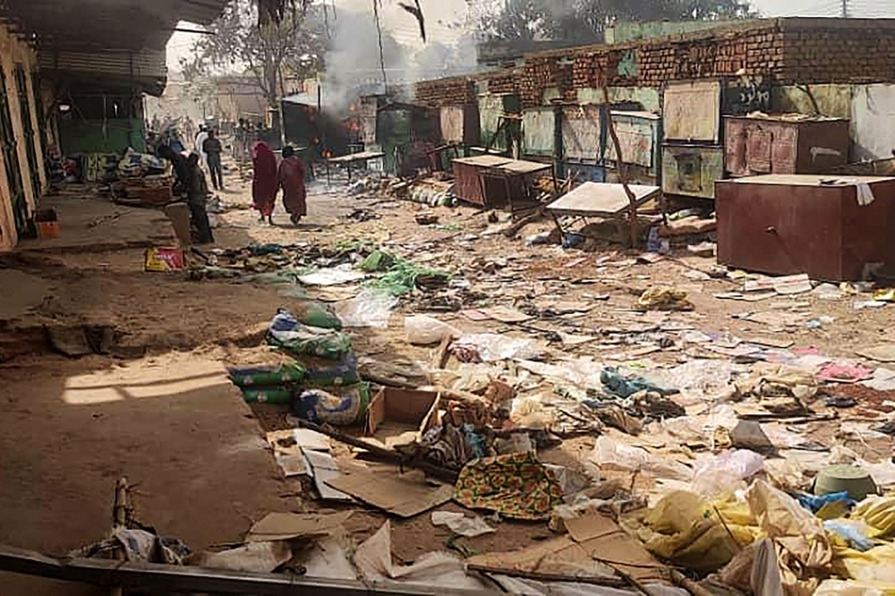 File Photo: People walk among scattered objects in the market of El Geneina, the capital of West Darfur on April 29, 2023. (AFP)

