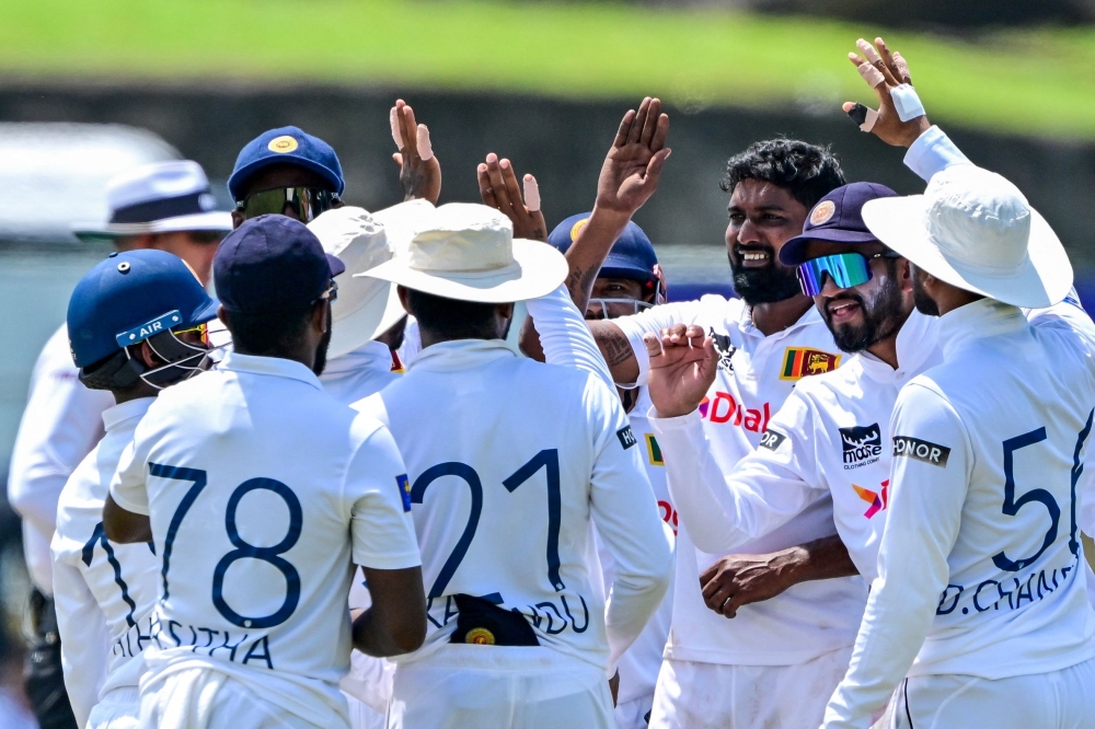 Sri Lanka's Prabath Jayasuriya (third left) celebrates with teammates after the dismissal of New Zealand's Tom Blundell during the third day of the second Test cricket match between Sri Lanka and New Zealand at the Galle International Cricket Stadium in Galle on September 28, 2024. (Photo by Ishara S. Kodikara / AFP)

