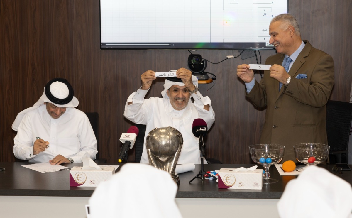 QBF General-Secretary Saadoun Sabah Al Kuwari displays a team as he takes part in the draw ceremony for the Qatar Cup yesterday. 