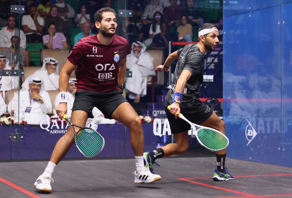 Qatar’s Abdullah Al Tamimi (right) plays a backhand shot against Egypt’s Karim Abdel Gawad during their match yesterday. 