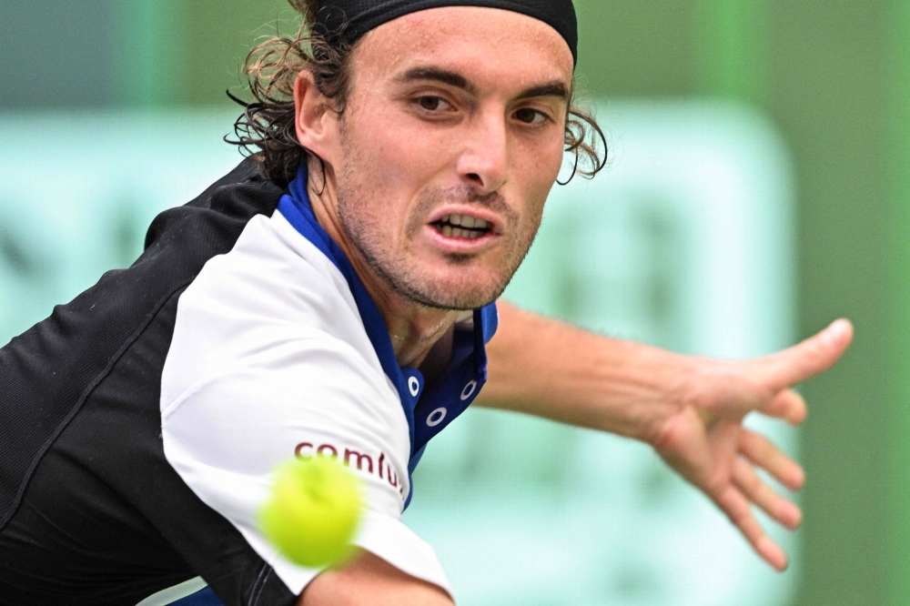 Greece's Stefanos Tsitsipas hits a return to Japan's Kei Nishikori during their men's singles match at the Shanghai Masters tennis tournament in Shanghai on October 4, 2024. (Photo by Hector RETAMAL / AFP)