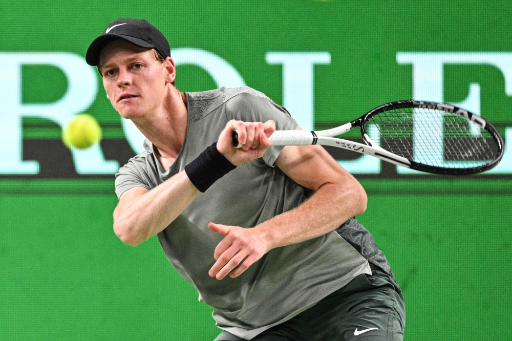 Italy's Jannik Sinner hits a return to Japan's Taro Daniel during their men's singles match at the Shanghai Masters tennis tournament in Shanghai on October 5, 2024. (Photo by Hector Retamal / AFP)