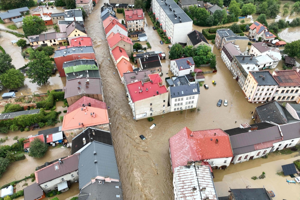 (Files) This aerial photograph taken on September 15, 2024 shows a view of the flooded streets in Glucholazy, southern Poland. (Photo by Sergei Gapon / AFP)