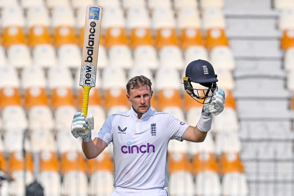 England's Joe Root celebrates after scoring a century (100 runs) during the third day of the first Test cricket match between Pakistan and England at the Multan Cricket Stadium in Multan on October 9, 2024. (Photo by Aamir Qureshi / AFP)
 