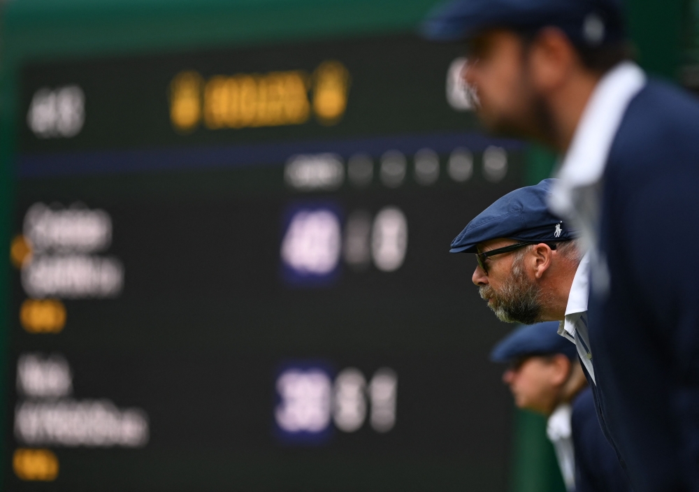 Line-Judges stare the court during the men's singles quarter final tennis match between Australia's Nick Kyrgios and Chile's Cristian Garin on the tenth day of the 2022 Wimbledon Championships at The All England Tennis Club in Wimbledon, southwest London, on July 6, 2022. Photo by Glyn KIRK / AFP