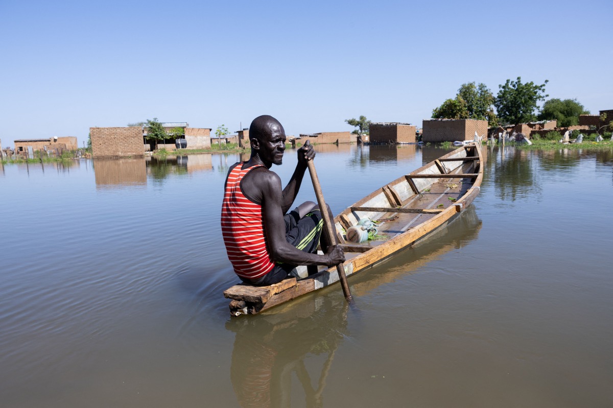 A man navigates a pirogue between the houses of the Tougoude district, in the south-east of Ndjamena's ninth arrondissement, flooded by the Logone River, on October 8, 2024. (Photo by Joris Bolomey / AFP)
