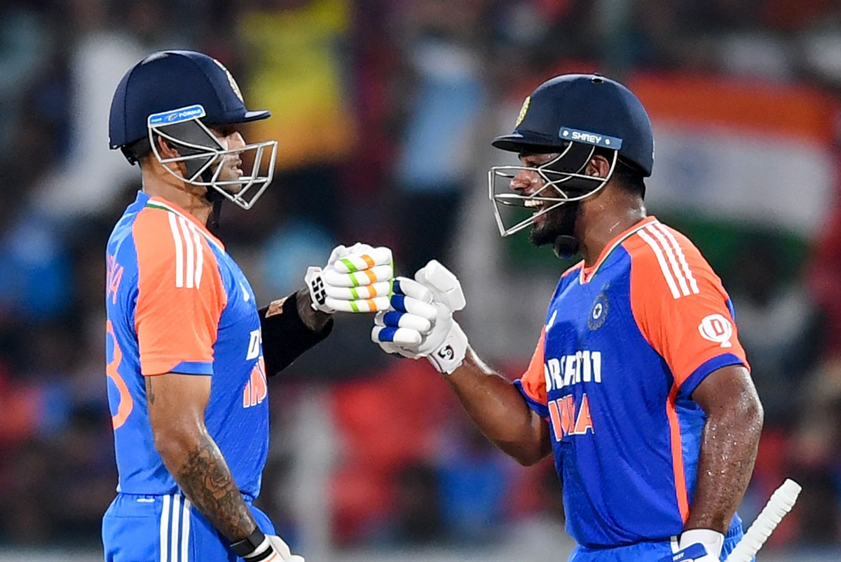 India's Sanju Samson (R) and captain Suryakumar Yadav bump their fists during the third and final Twenty20 international cricket match between India and Bangladesh at the Rajiv Gandhi International Stadium in Hyderabad on October 12, 2024. (Photo by Noah SEELAM / AFP)