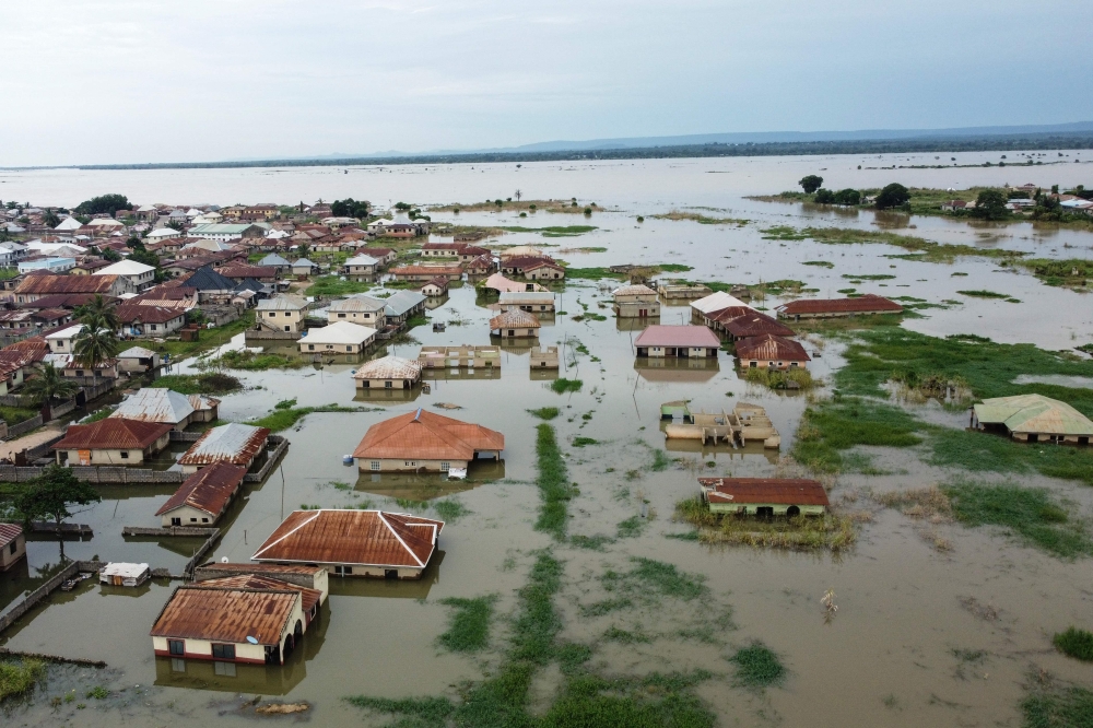 This aerial view shows houses submerged under water in Adankolo in Kogi State on October 12, 2024. (Photo by Haruna Yahaya / AFP)