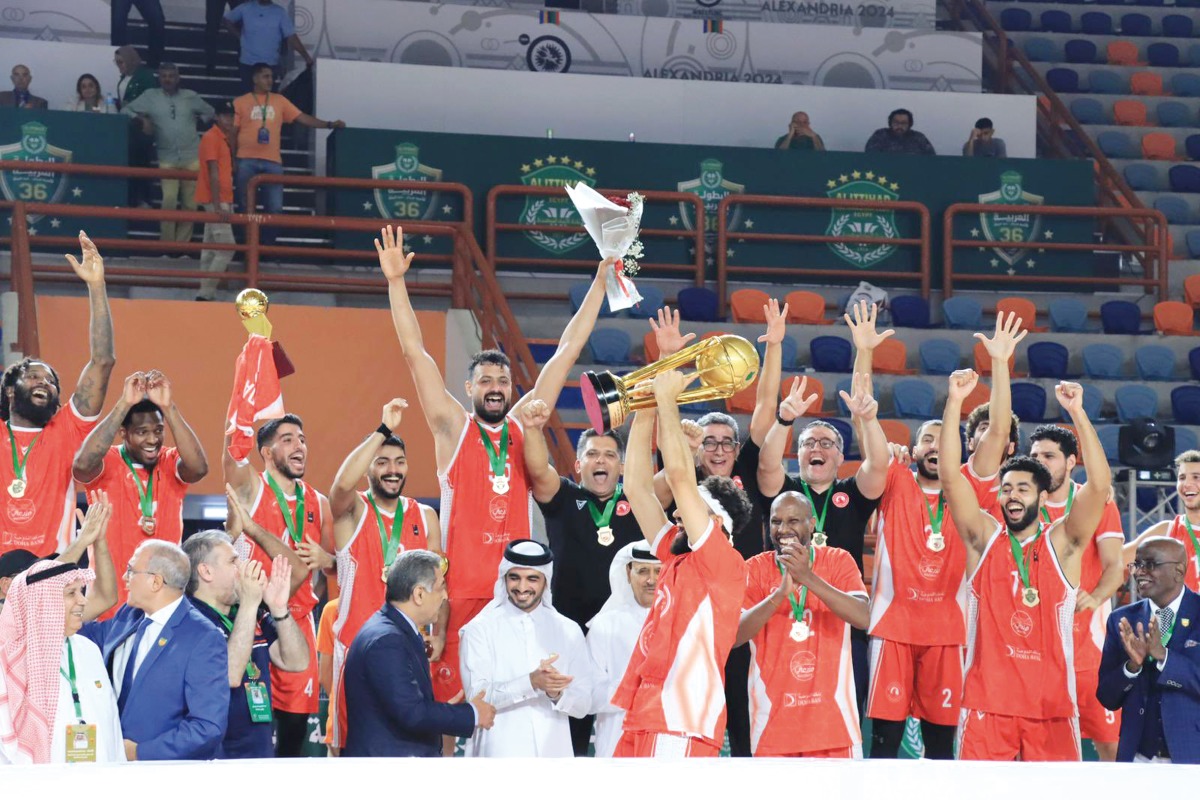 Al Arabi players and officials celebrate after winning the Arab Clubs Men’s Basketball title.