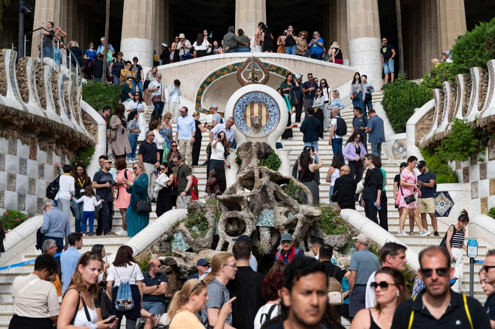 Tourists visit Park Guell in Barcelona on October 11, 2024. (Photo by Josep Lago / AFP)