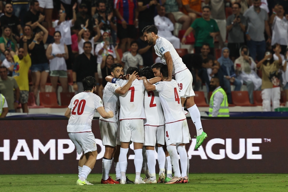 Iran's players celebrate a goal during the 2026 FIFA World Cup AFC qualifiers group A football match between Iran and Qatar at the Rashid Stadium in Dubai on October 15, 2024. (Photo by Fadel Senna / AFP)