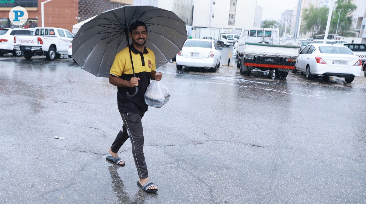 A pedestrian carrying an umbrella to protect himself from the rainfall in Doha, Qatar, on Friday October 11, 2024. Photo by Rajan Vadakkemuriyil / The Peninsula