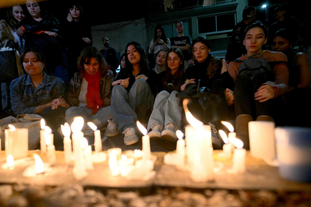 Fans of British singer Liam Payne lit candles next to the hotel where he died in Buenos Aires on October 16, 2024. Photo by Luis ROBAYO / AFP