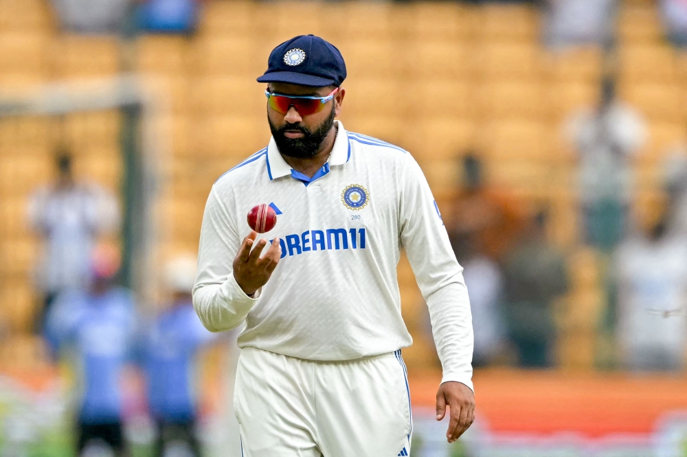 India's captain Rohit Sharma fields the ball during the fifth and final day of the first Test cricket match between India and New Zealand on October 20, 2024. (Photo by Idrees Mohammed / AFP) 