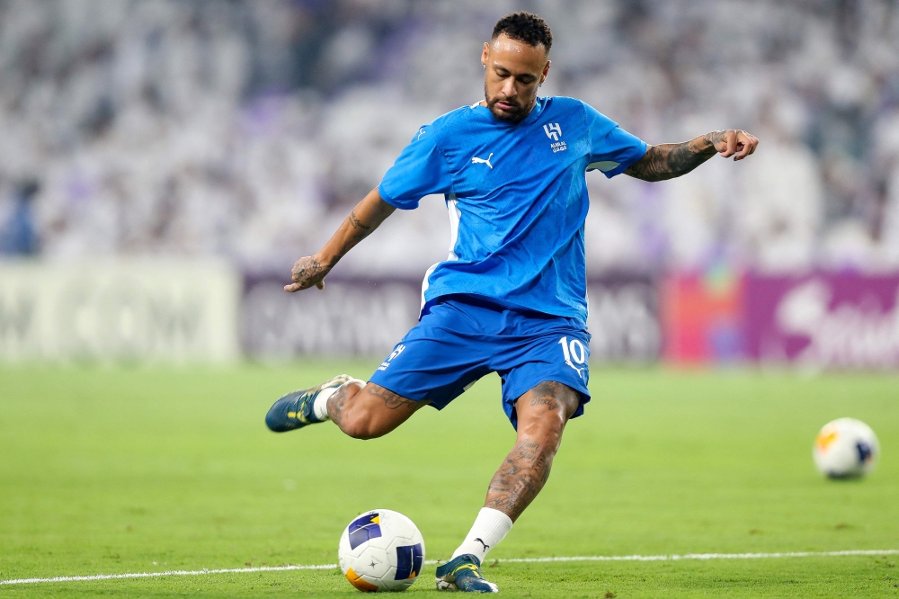 Hilal's Brazilian forward #10 Neymar warms up ahead of the AFC Champions League group B football match between UAE's Al-Ain and Saudi's Al-Hilal at the Hazza bin Zayed Stadium in al-Ain on October 21, 2024. (Photo by AFP)