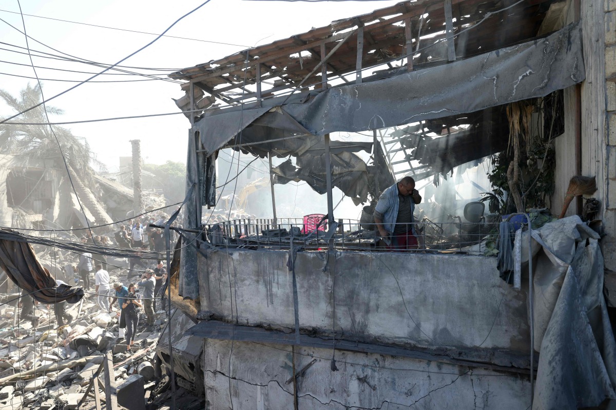 A man inspects the debris a day after an Israeli airstrike in Beirut's southern suburb of Jnah on October 22, 2024. (Photo by IBRAHIM AMRO / AFP)
