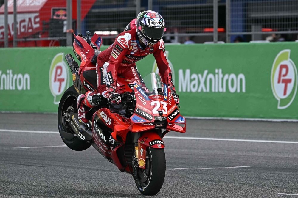 Ducati Lenovo Team's Italian rider Enea Bastianini celebrates winning the Sprint race of the MotoGP Thailand Grand Prix at the Buriram International Circuit in Buriram on October 26, 2024. (Photo by Lillian SUWANRUMPHA / AFP)
 