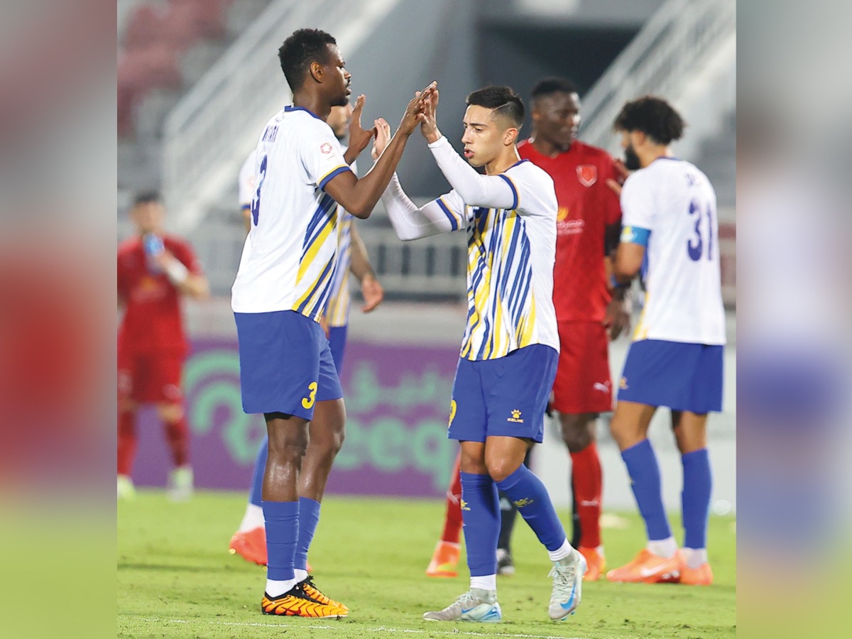 Al Gharafa's Mohammed Muntari (left) celebrates with teammates after scoring the equaliser against Al Duhail.