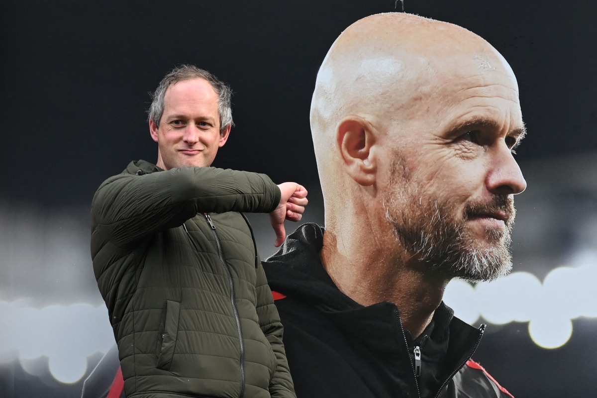 A visitor reacts as he poses in front of a picture of newly sacked Manchester United's Dutch manager Erik Ten Hag, outside Old Trafford, in Manchester, north west England, on October 28, 2024. (Photo by Paul ELLIS / AFP)
